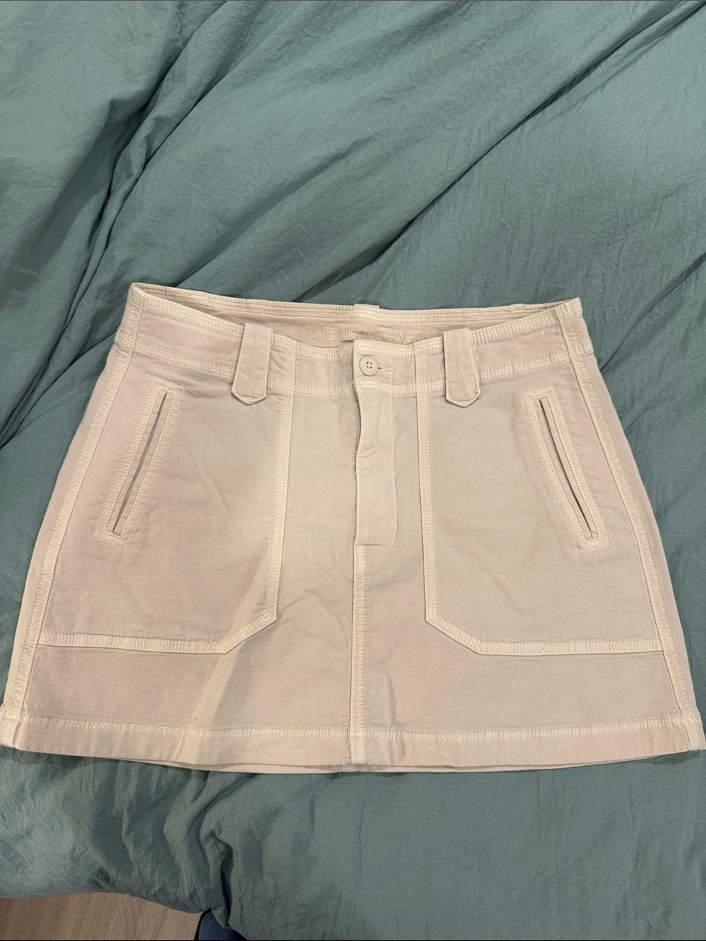 American Eagle Outfitters Cream Mini Skirt with Front Pockets